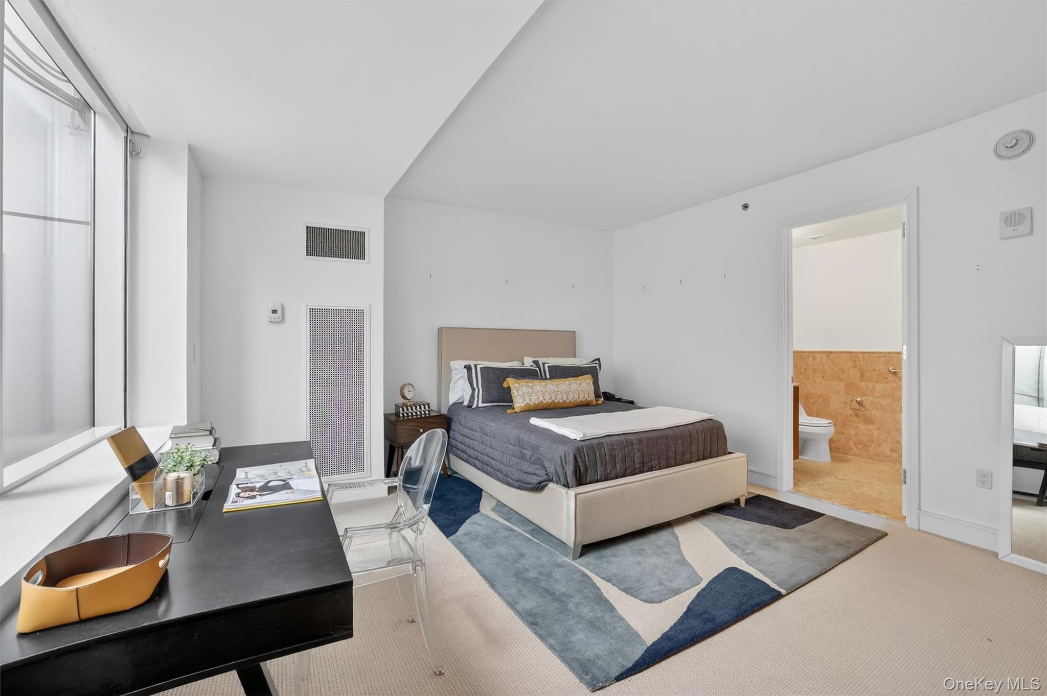 5 Renaissance Square, Unit 10G White Plains, NY 10601 - Photo 24 of 27 a bedroom with a bed table and a window