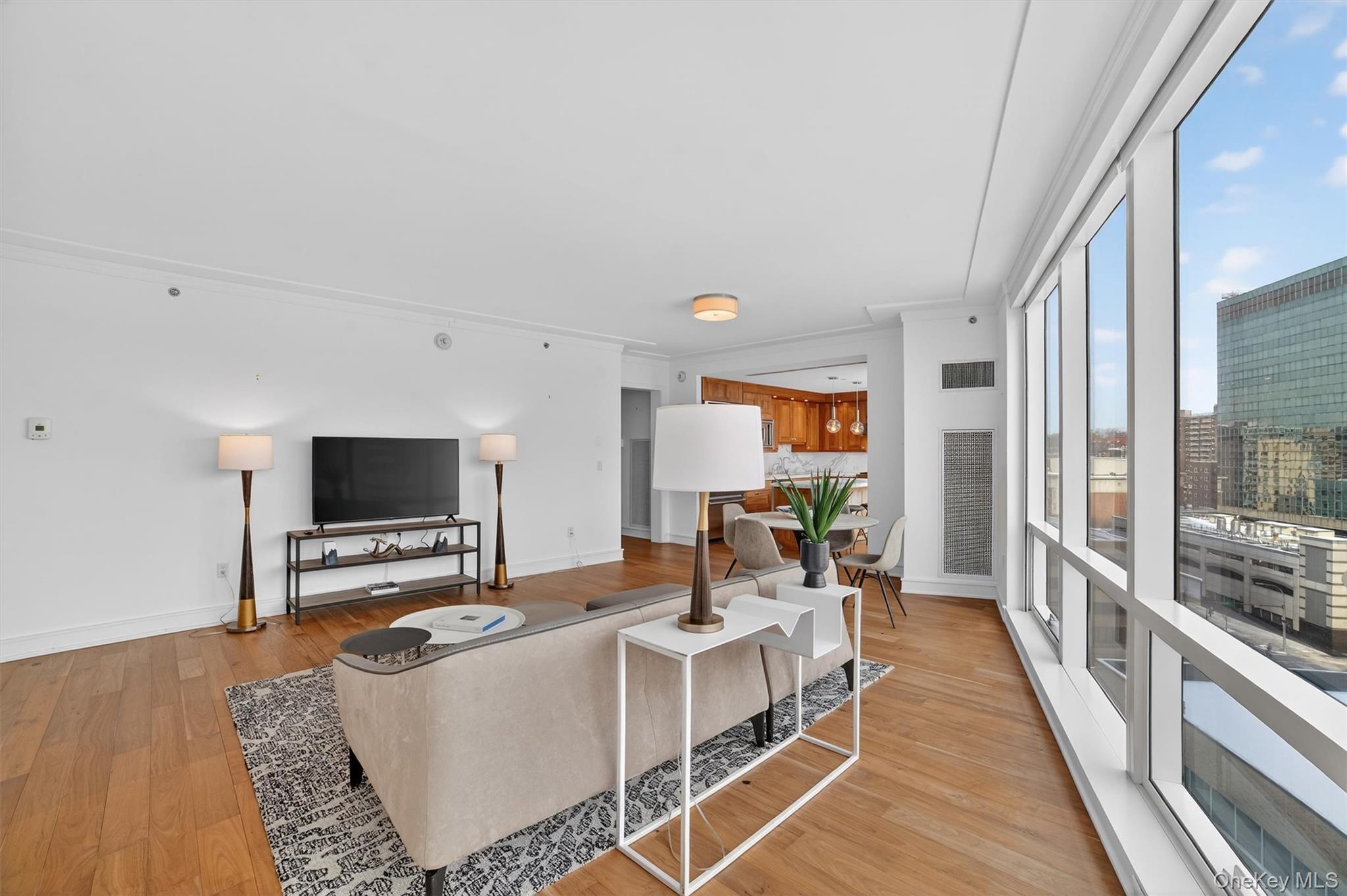 5 Renaissance Square, Unit 10G White Plains, NY 10601 - Photo 7 of 27 a living room with furniture and a flat screen tv