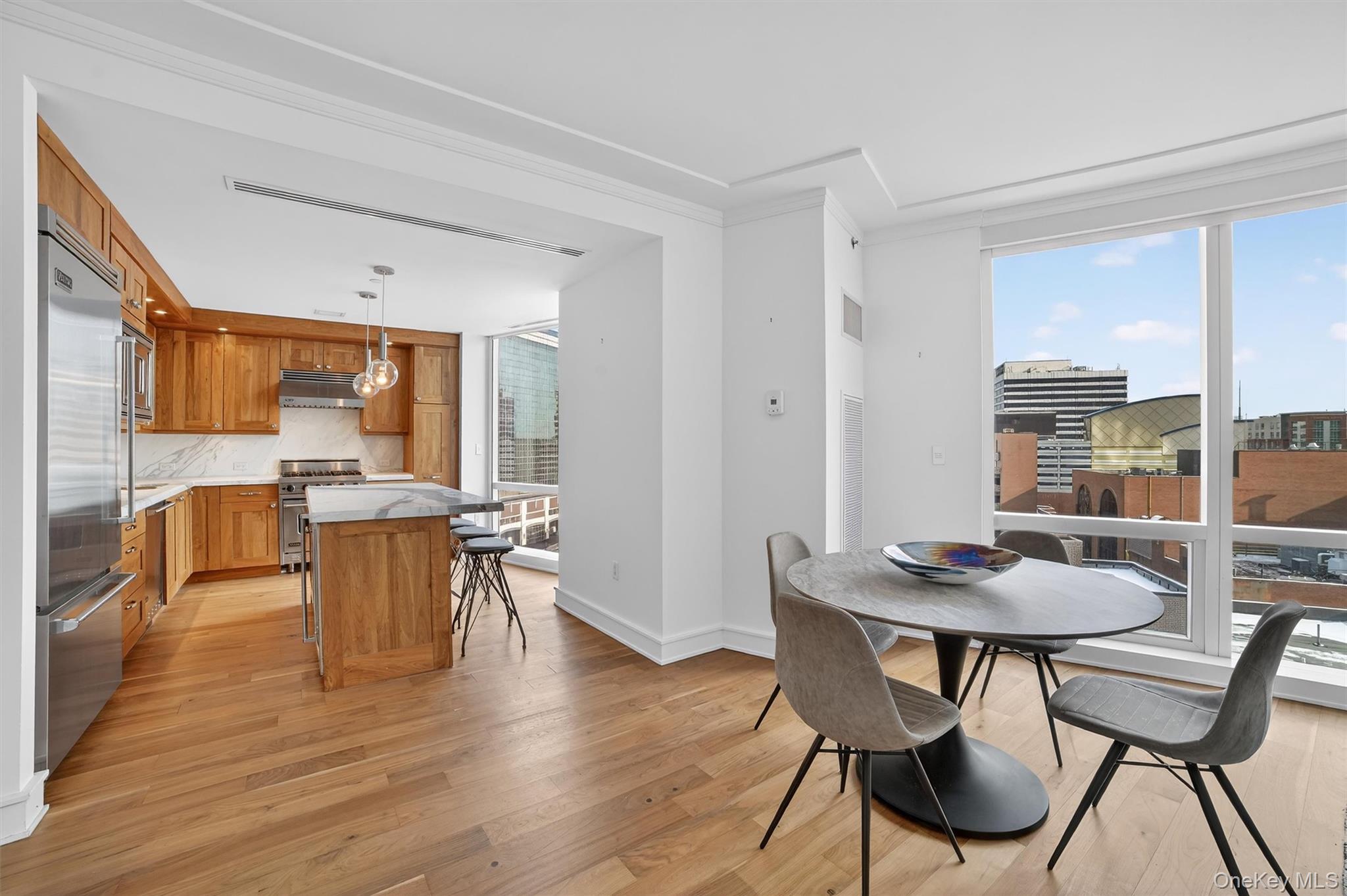 5 Renaissance Square, Unit 10G White Plains, NY 10601 - Photo 8 of 27 a dining room with furniture and wooden floor