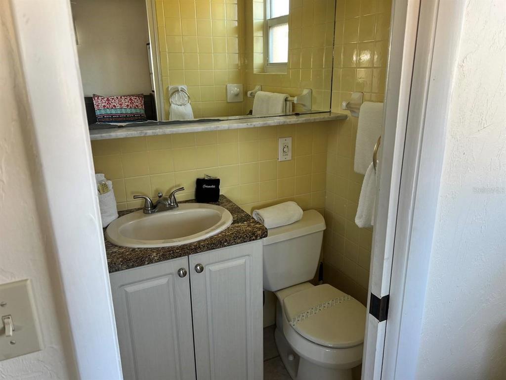 6006 Midnight Pass Road, Unit 40 Sarasota, FL 34242 - Photo 11 of 25 a bathroom with a granite countertop toilet and a sink