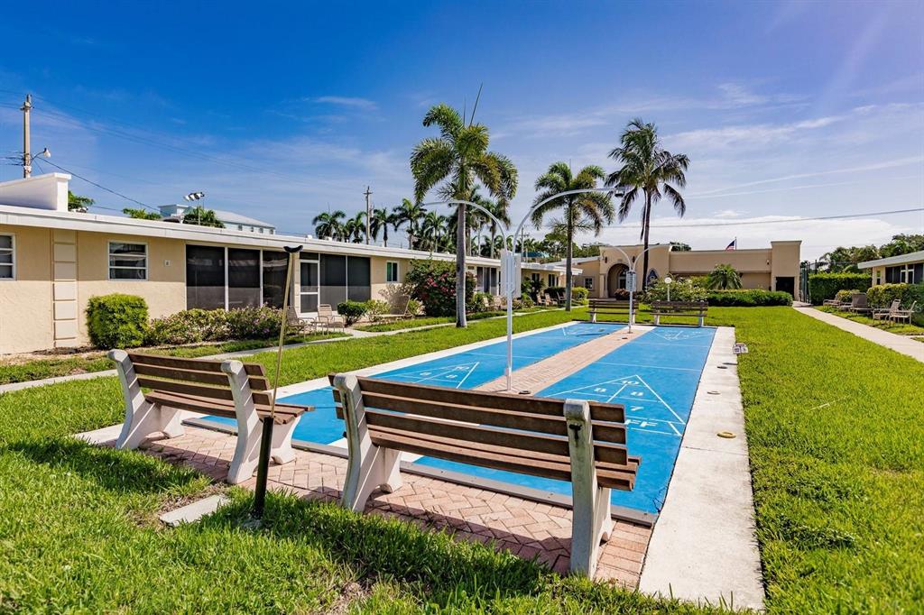 6006 Midnight Pass Road, Unit 40 Sarasota, FL 34242 - Photo 20 of 25 a front view of a house with garden