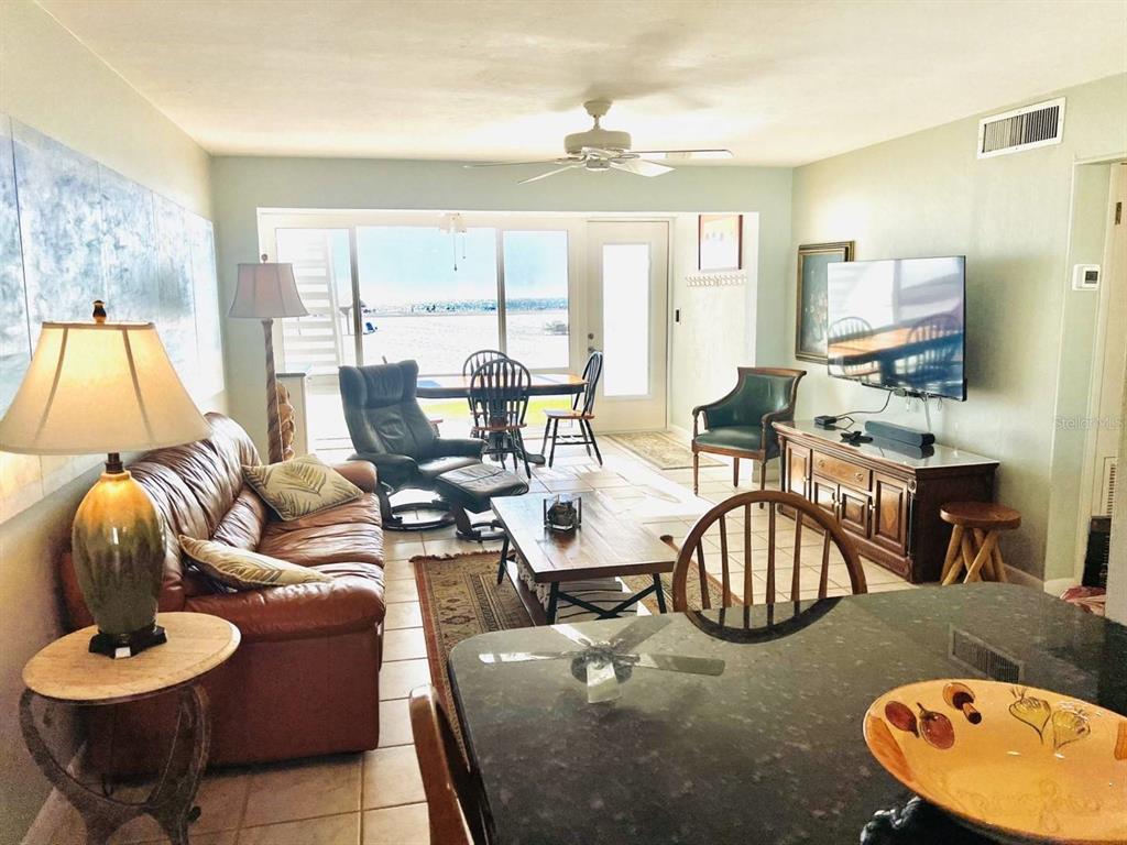 6006 Midnight Pass Road, Unit 40 Sarasota, FL 34242 - Photo 2 of 25 a living room with furniture and a large window
