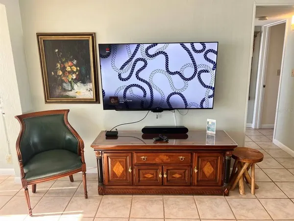 a view of a dining room with furniture and a potted plant