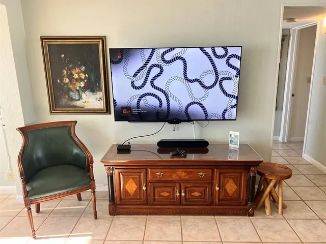 a view of a dining room with furniture and a potted plant