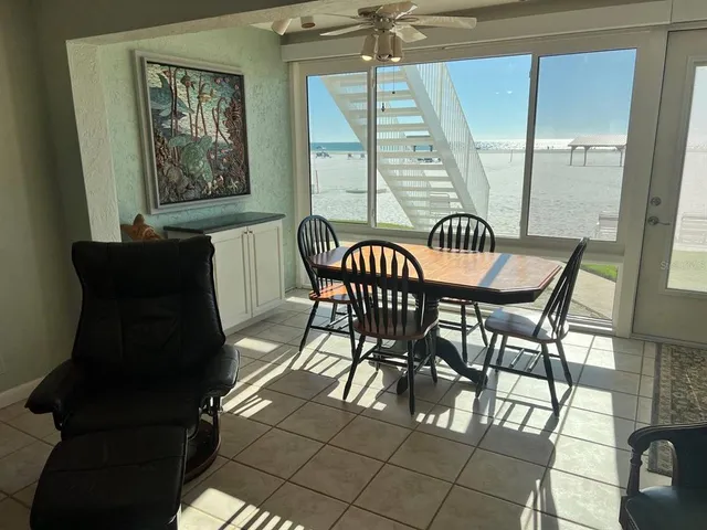 a kitchen with stainless steel appliances granite countertop a sink a stove a microwave a refrigerator and island