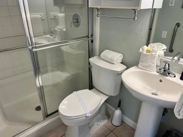 a bedroom with two beds and a large window