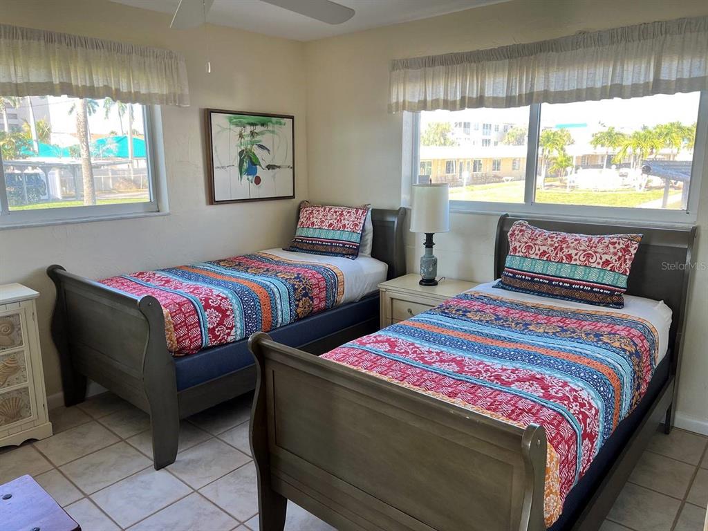 6006 Midnight Pass Road, Unit 40 Sarasota, FL 34242 - Photo 10 of 25 a bedroom with two beds and a large window