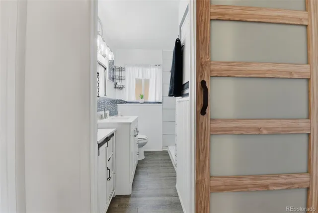 a bathroom with a sink a toilet and vanity