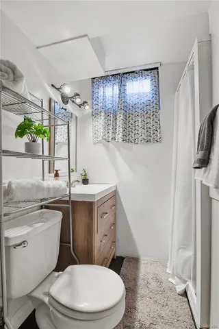 a bathroom with a toilet a sink and a shower