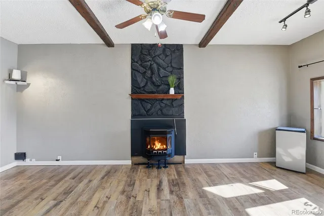 wooden floor in an empty room with a fireplace