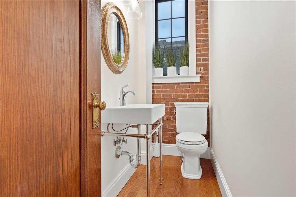 4749 Wallingford Street Pittsburgh, PA 15213 - Photo 23 of 49 a bathroom with a toilet sink and mirror