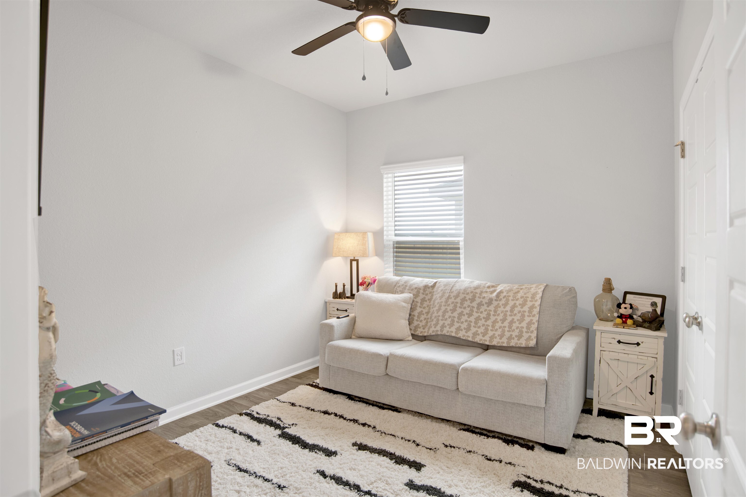 12813 Patriot Way Daphne, AL 36527 - Photo 13 of 23 Compact interior room featuring light gray walls, wood-finish flooring, and a ceiling fan with integrated lighting