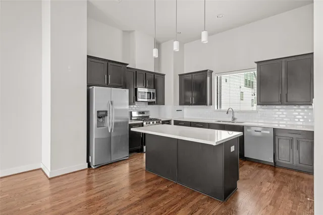 a large kitchen with cabinets and stainless steel appliances