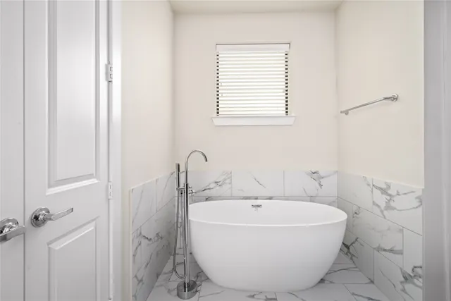 a white bath tub sitting next to a white sink