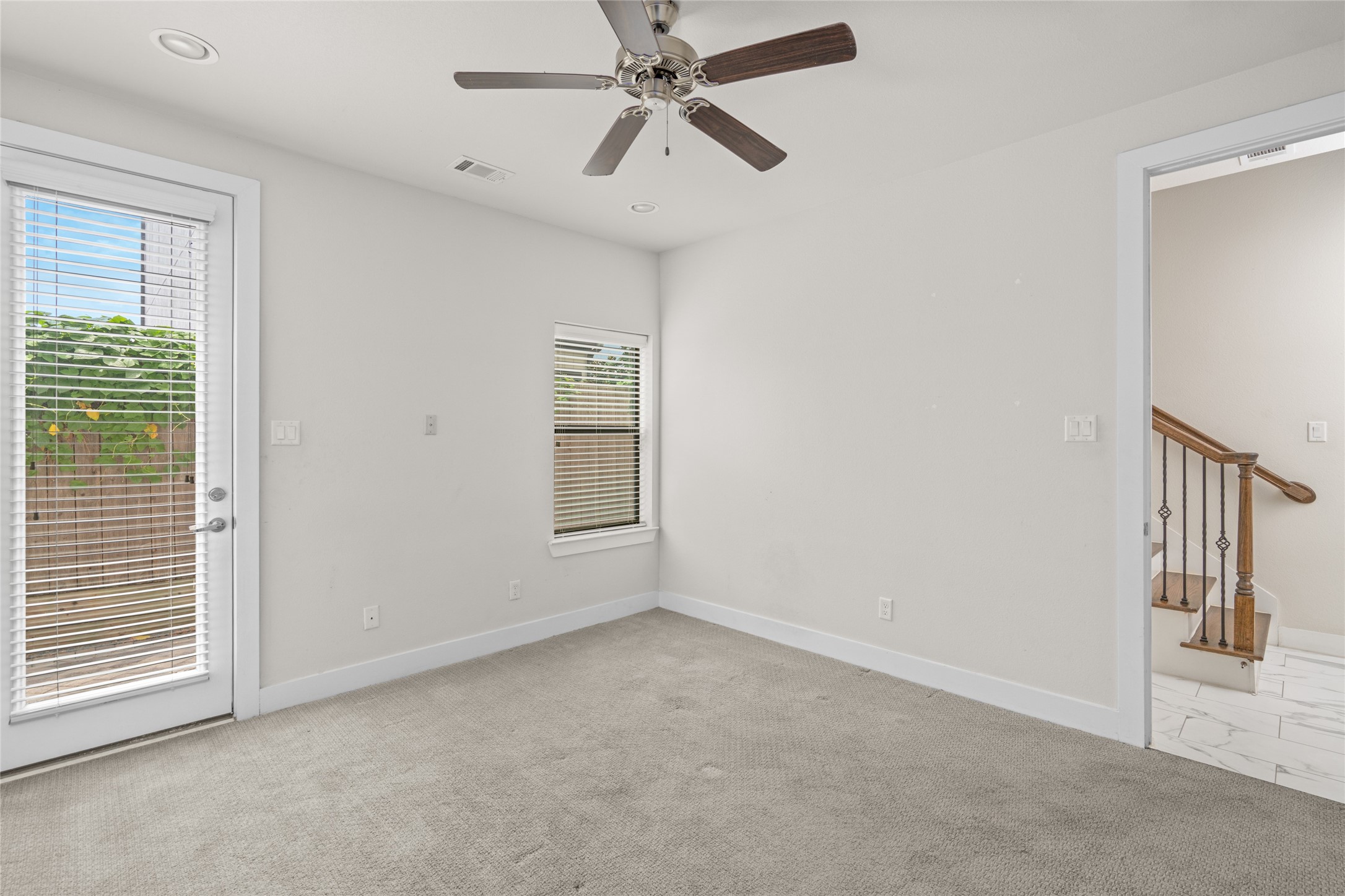 3409 Kensington Yellow Place Houston, TX 77008 - Photo 6 of 28 an empty room with windows and fan