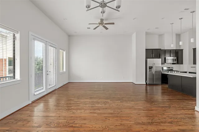 a view of kitchen with granite countertop cabinets and refrigerator