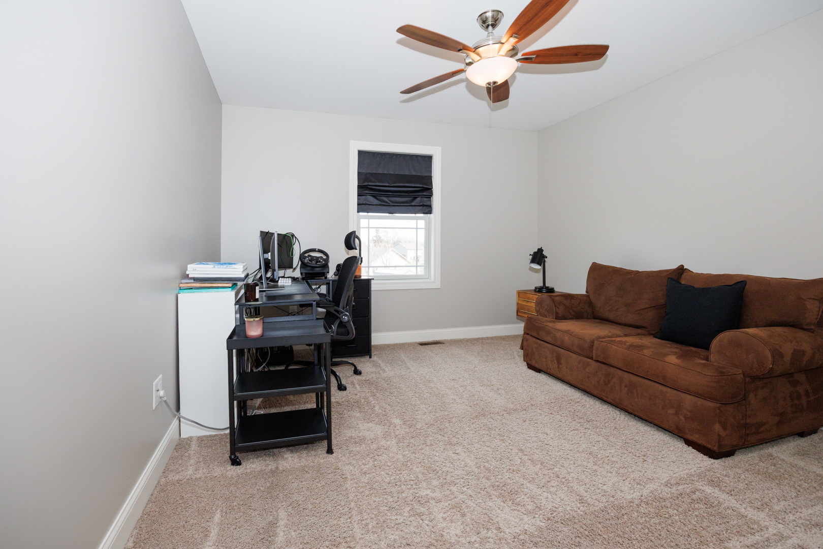 114 Mallard Way Hudson, IL 61748 - Photo 33 of 65 a living room with furniture a ceiling fan and a window