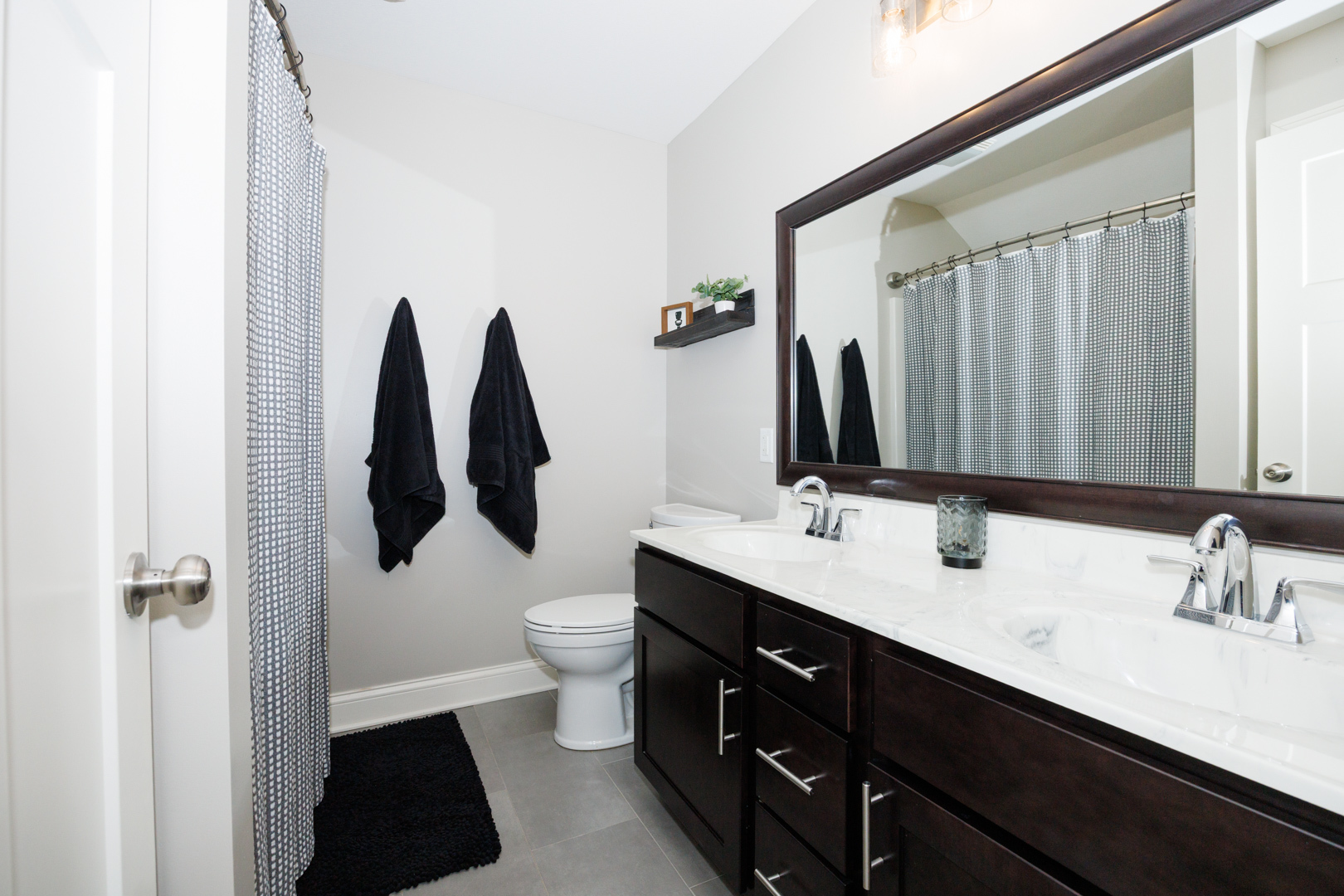 114 Mallard Way Hudson, IL 61748 - Photo 38 of 65 a bathroom with a double vanity sink and a mirror