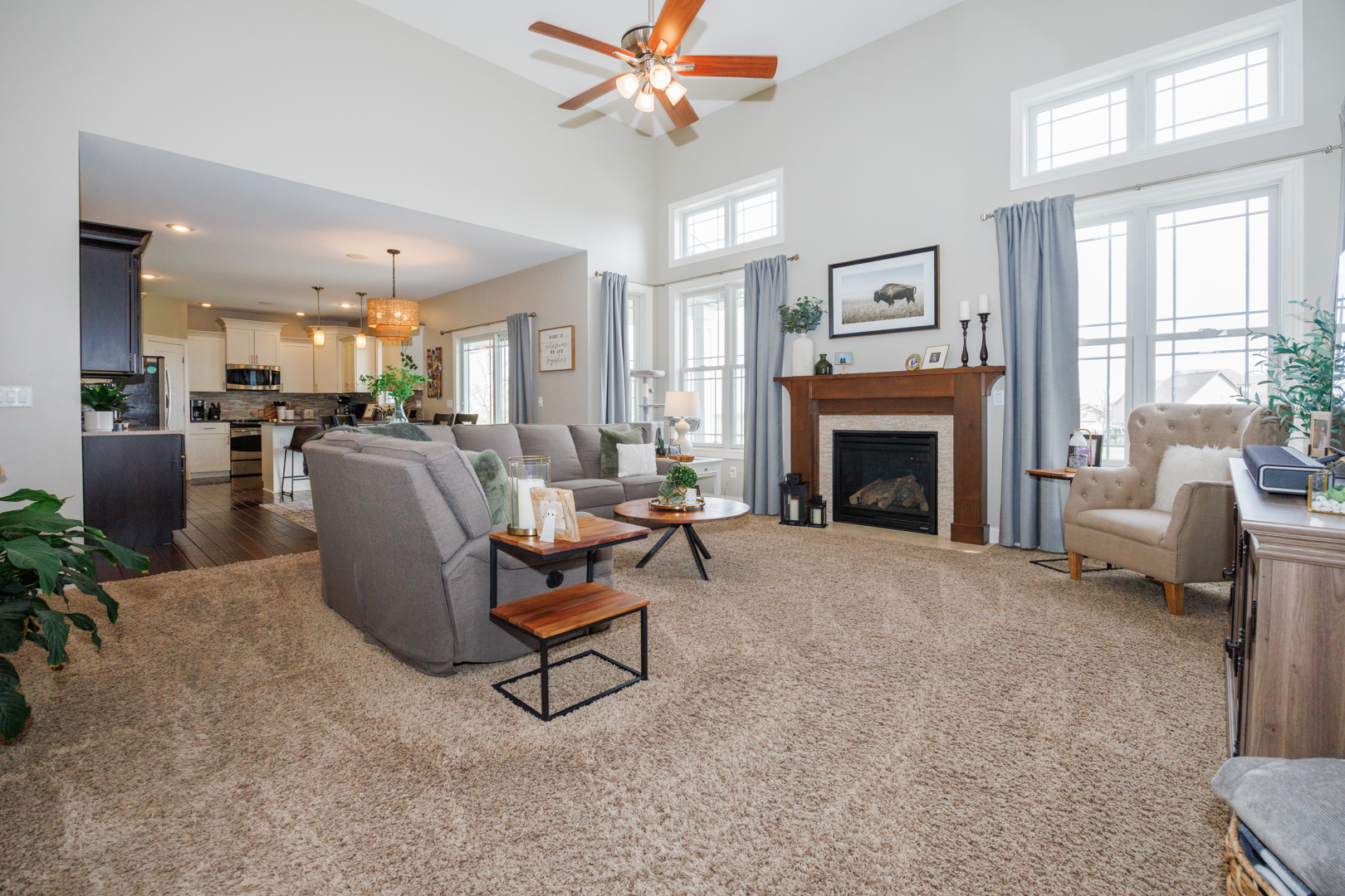 114 Mallard Way Hudson, IL 61748 - Photo 4 of 65 a living room with furniture a fireplace and a chandelier