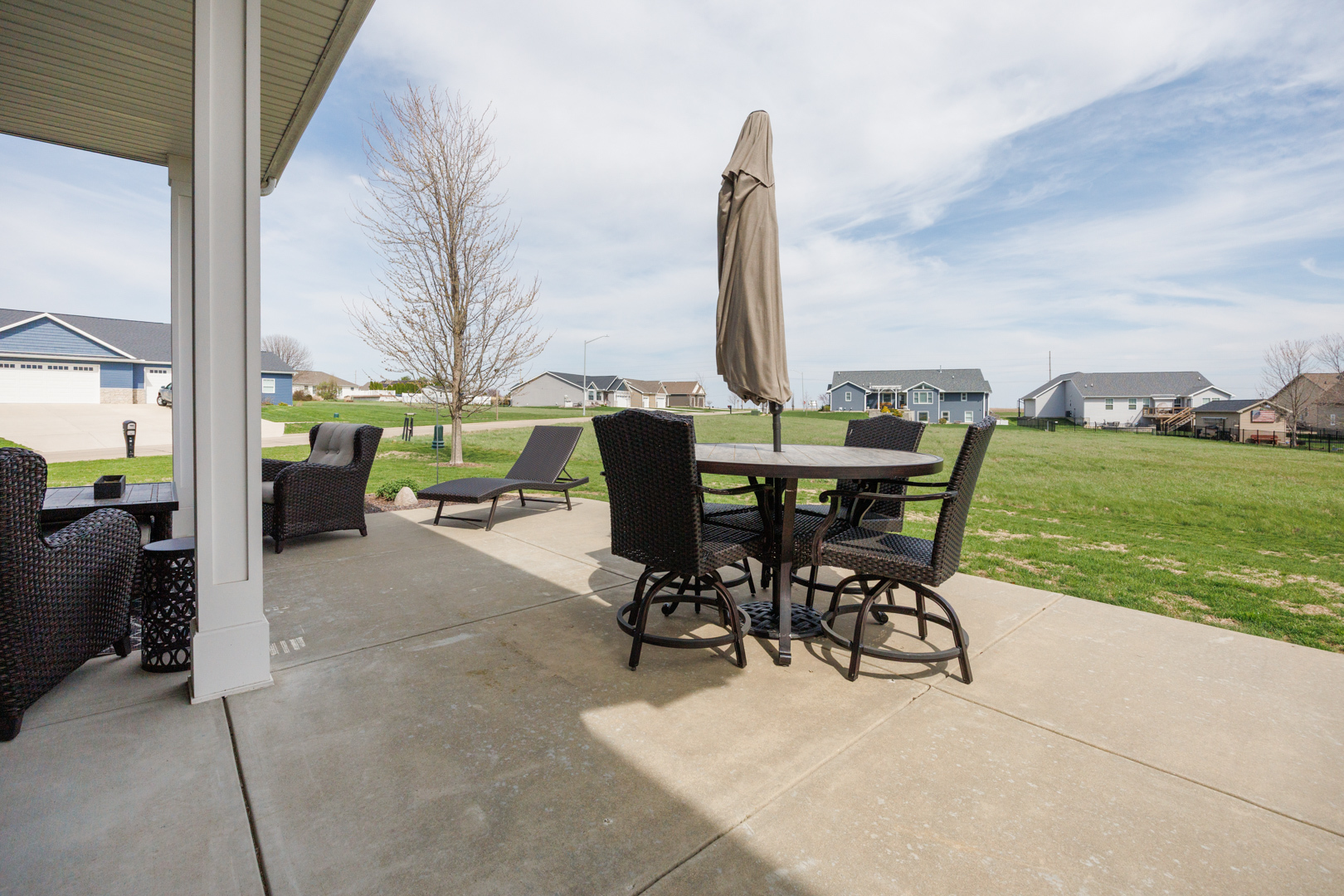 114 Mallard Way Hudson, IL 61748 - Photo 58 of 65 a view of a patio with a table chairs and a garden