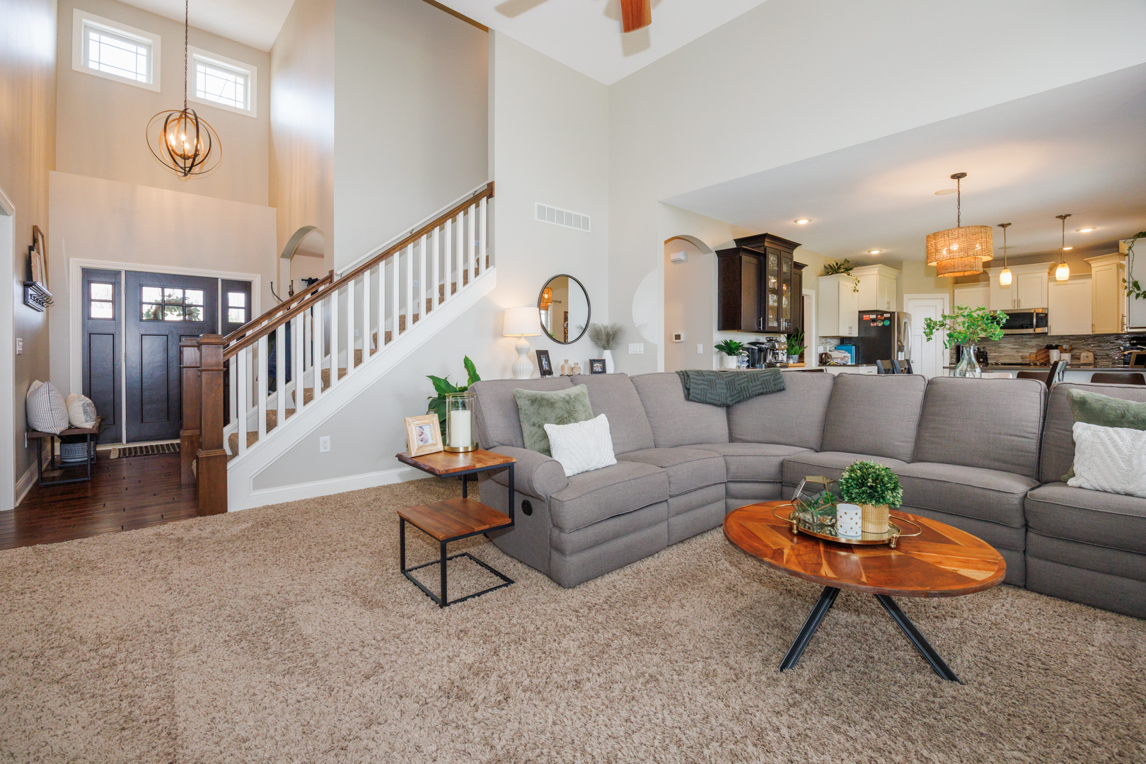 114 Mallard Way Hudson, IL 61748 - Photo 7 of 65 a living room with furniture a rug and a chandelier