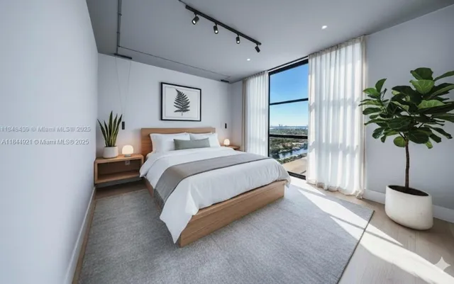 a bedroom with a bed and a potted plant