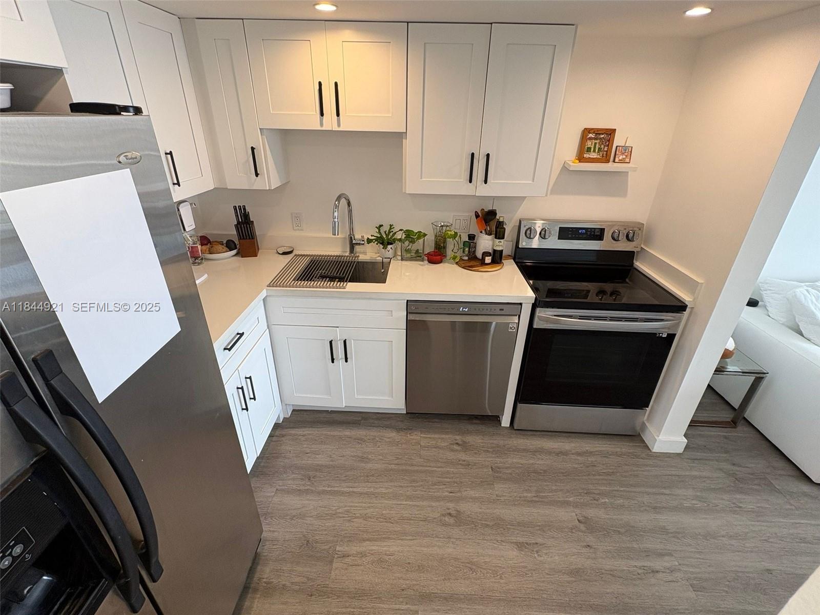 13499 Biscayne Boulevard, Unit 902 North Miami, FL 33181 - Photo 6 of 15 a utility room with sink dryer and washer