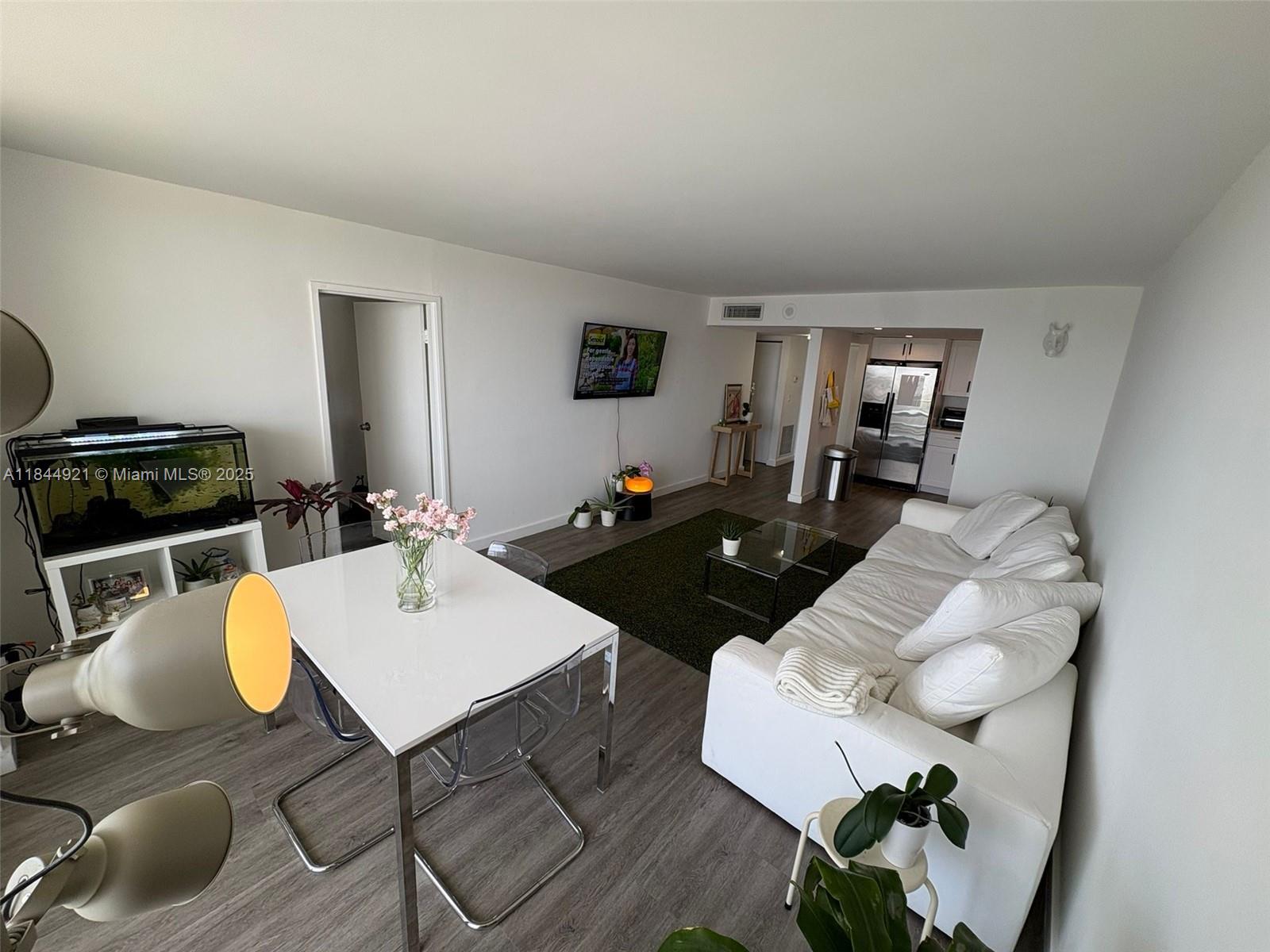 13499 Biscayne Boulevard, Unit 902 North Miami, FL 33181 - Photo 10 of 15 a living room with furniture and a table