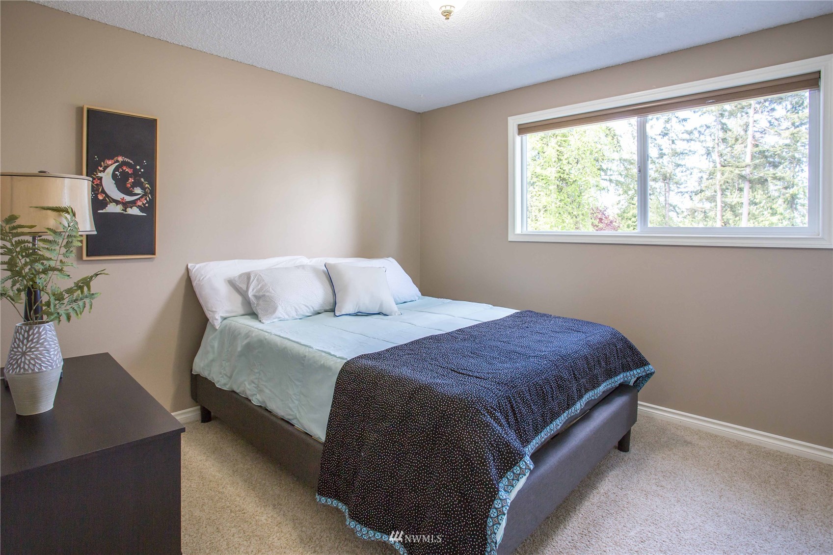 3951 Britton Road Bellingham, WA 98226 - Photo 27 of 39 a bedroom with a bed lamp and a potted plant