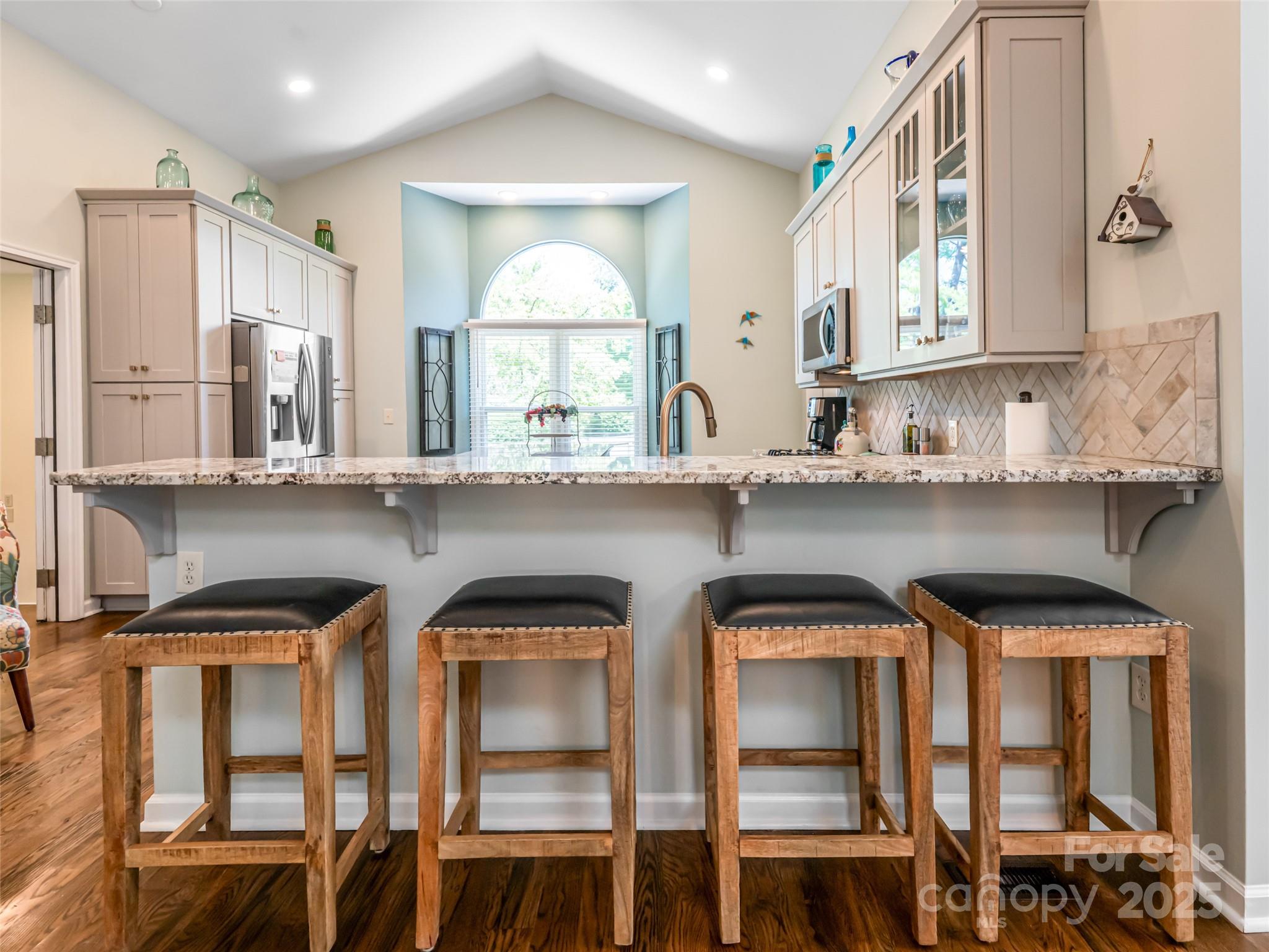 206 Pinner Road Arden, NC 28704 - Photo 13 of 47 a kitchen with a cabinets and chairs