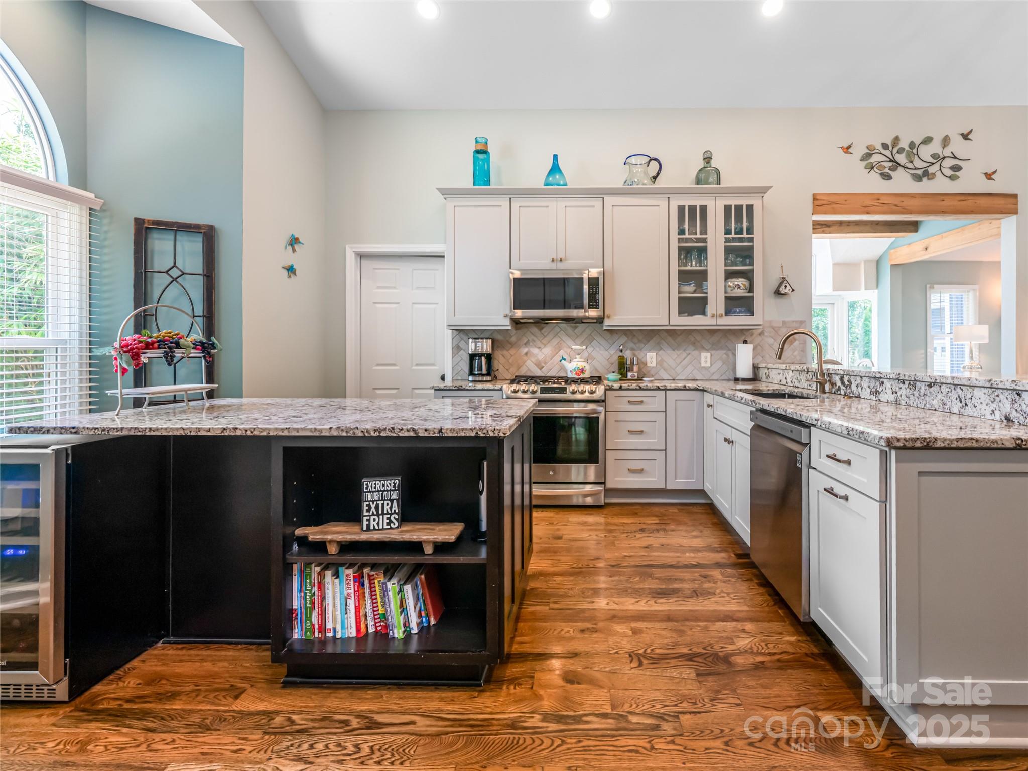 206 Pinner Road Arden, NC 28704 - Photo 14 of 47 a kitchen with stainless steel appliances granite countertop a stove and cabinets