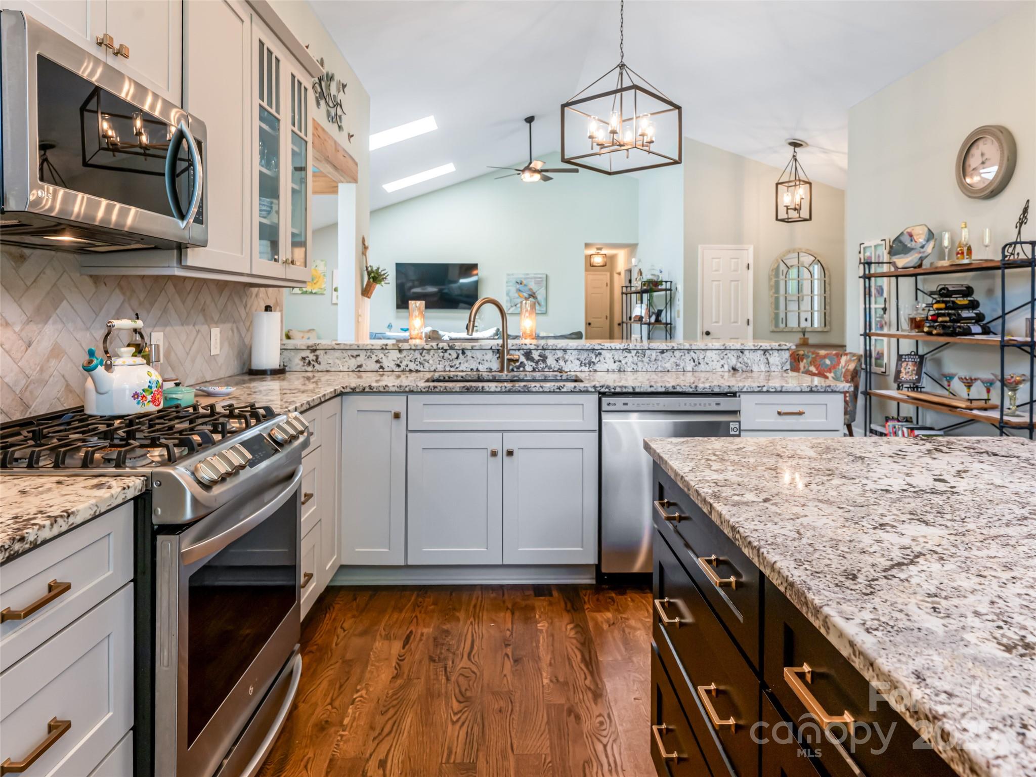 206 Pinner Road Arden, NC 28704 - Photo 16 of 47 a kitchen with stainless steel appliances granite countertop a stove and cabinets