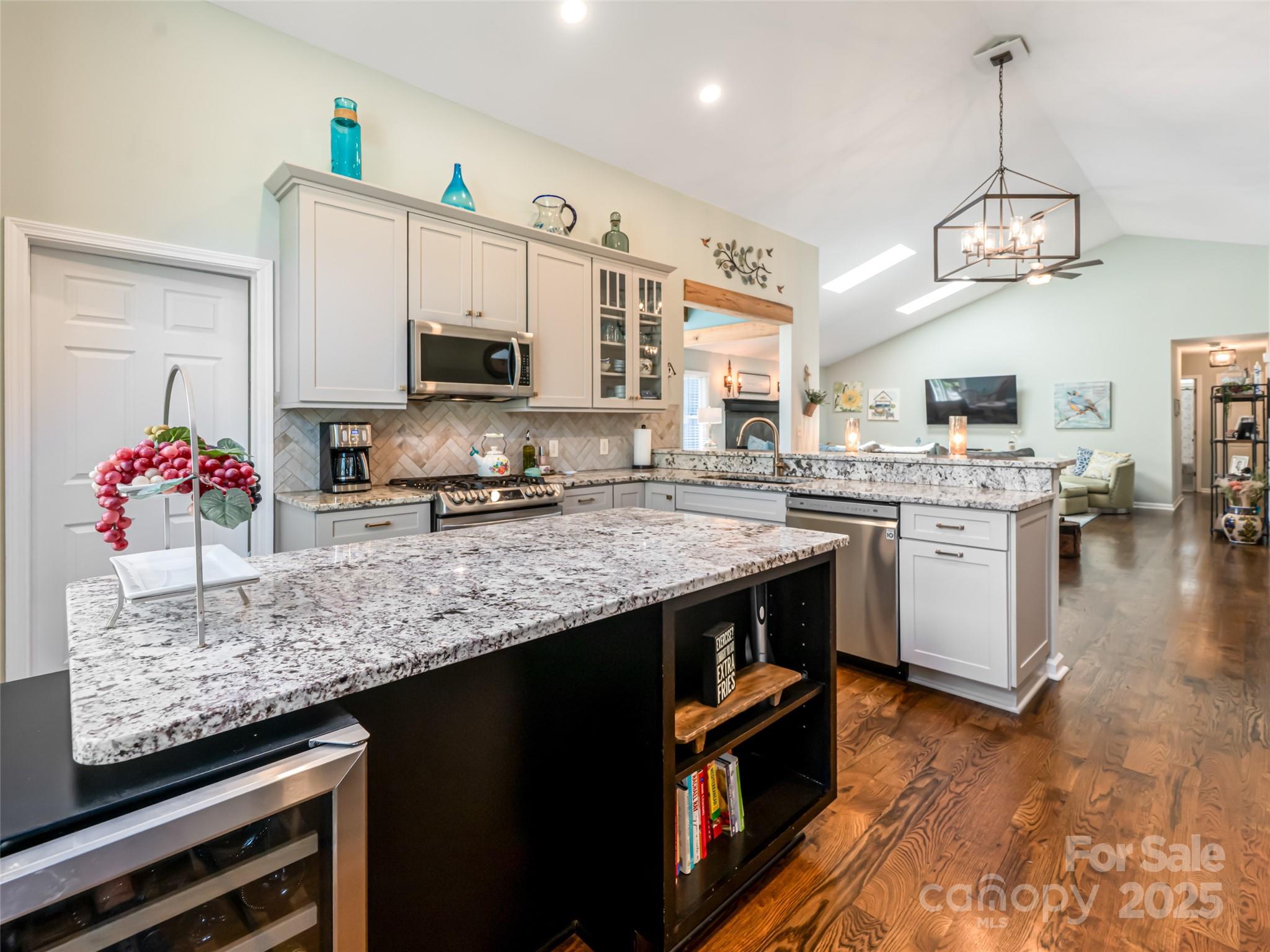 206 Pinner Road Arden, NC 28704 - Photo 18 of 47 a kitchen with stainless steel appliances granite countertop a sink a stove and a wooden floors