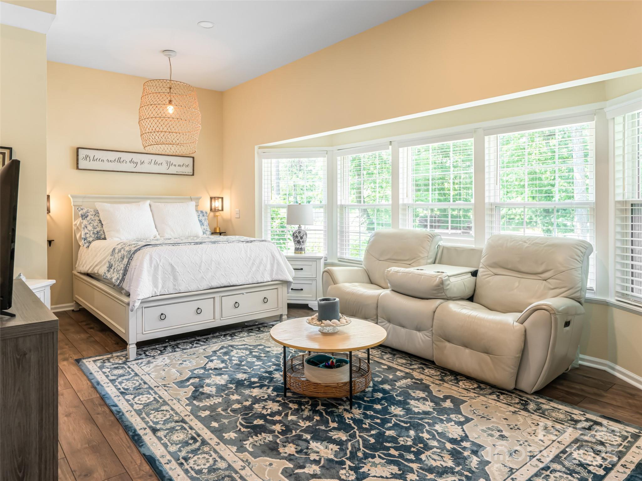 206 Pinner Road Arden, NC 28704 - Photo 22 of 47 a spacious bedroom with a bed a couch and a table