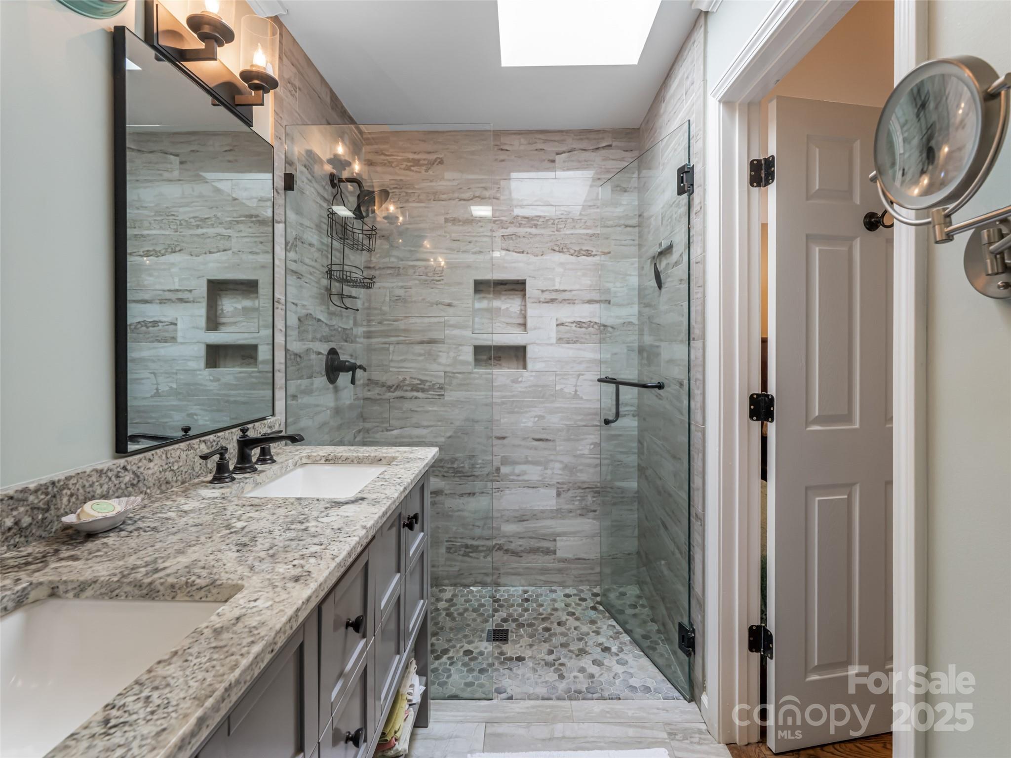 206 Pinner Road Arden, NC 28704 - Photo 31 of 47 a bathroom with a granite countertop shower a mirror and a sink