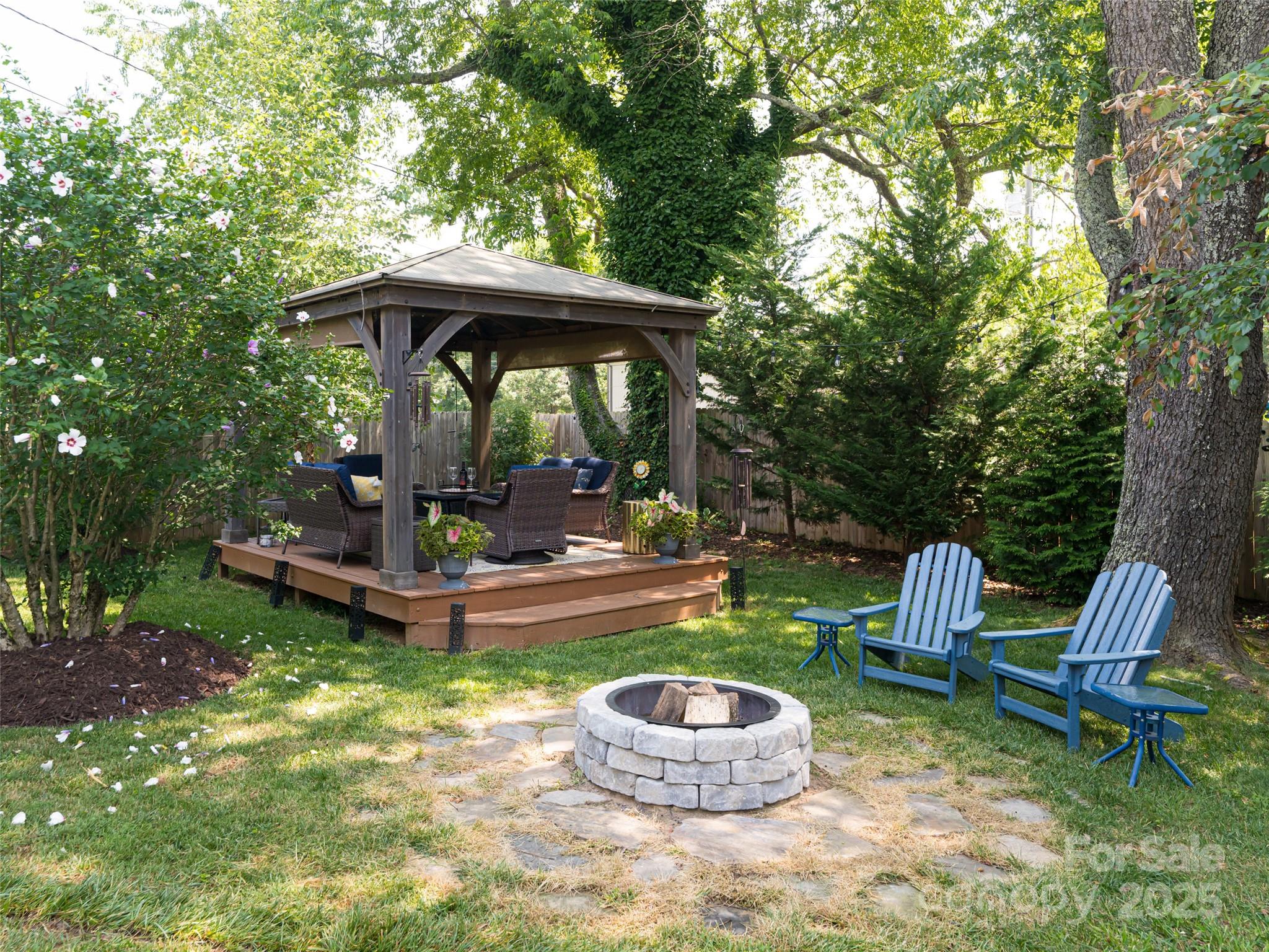 206 Pinner Road Arden, NC 28704 - Photo 38 of 47 a backyard of a house with table and chairs under an umbrella