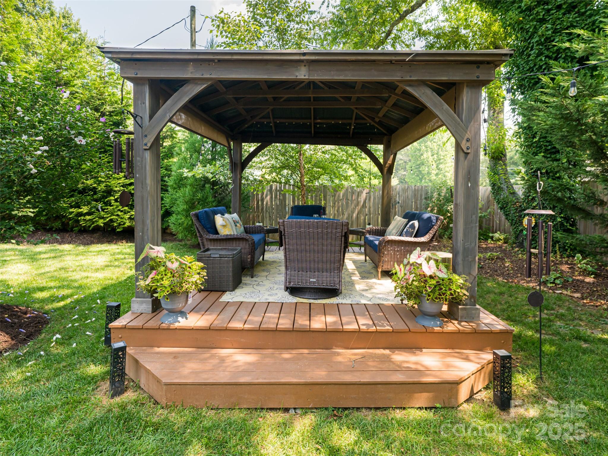 206 Pinner Road Arden, NC 28704 - Photo 39 of 47 a view of a wooden deck with a table and chairs under an umbrella
