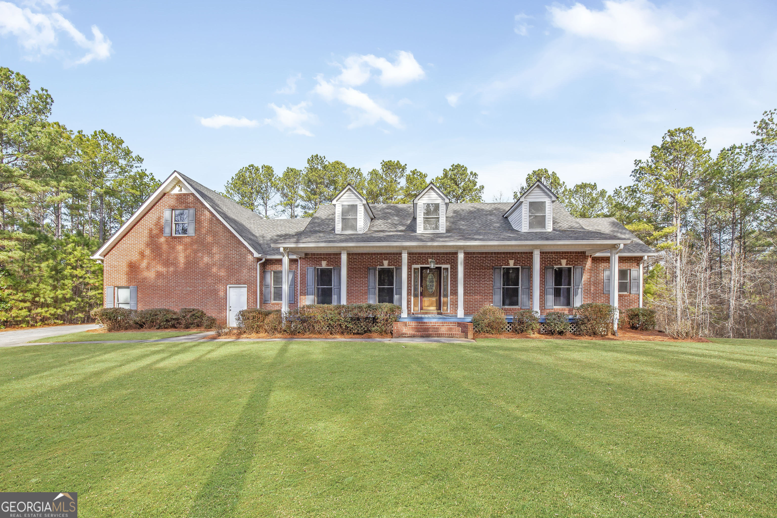 a front view of house with yard and green space