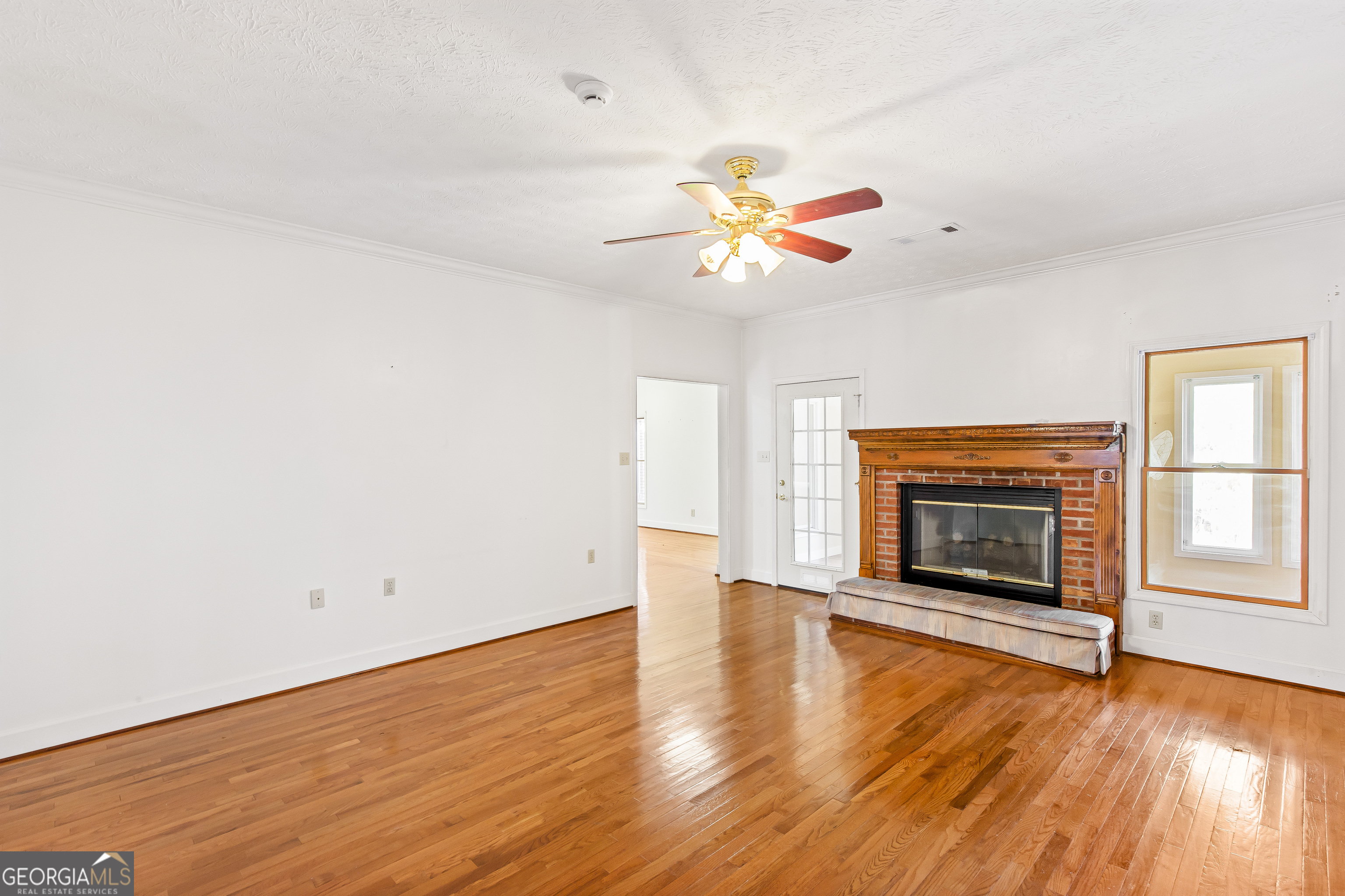 273 High Point Road Buchanan, GA 30113 - Photo 13 of 73 an empty room with wooden floor fireplace and window