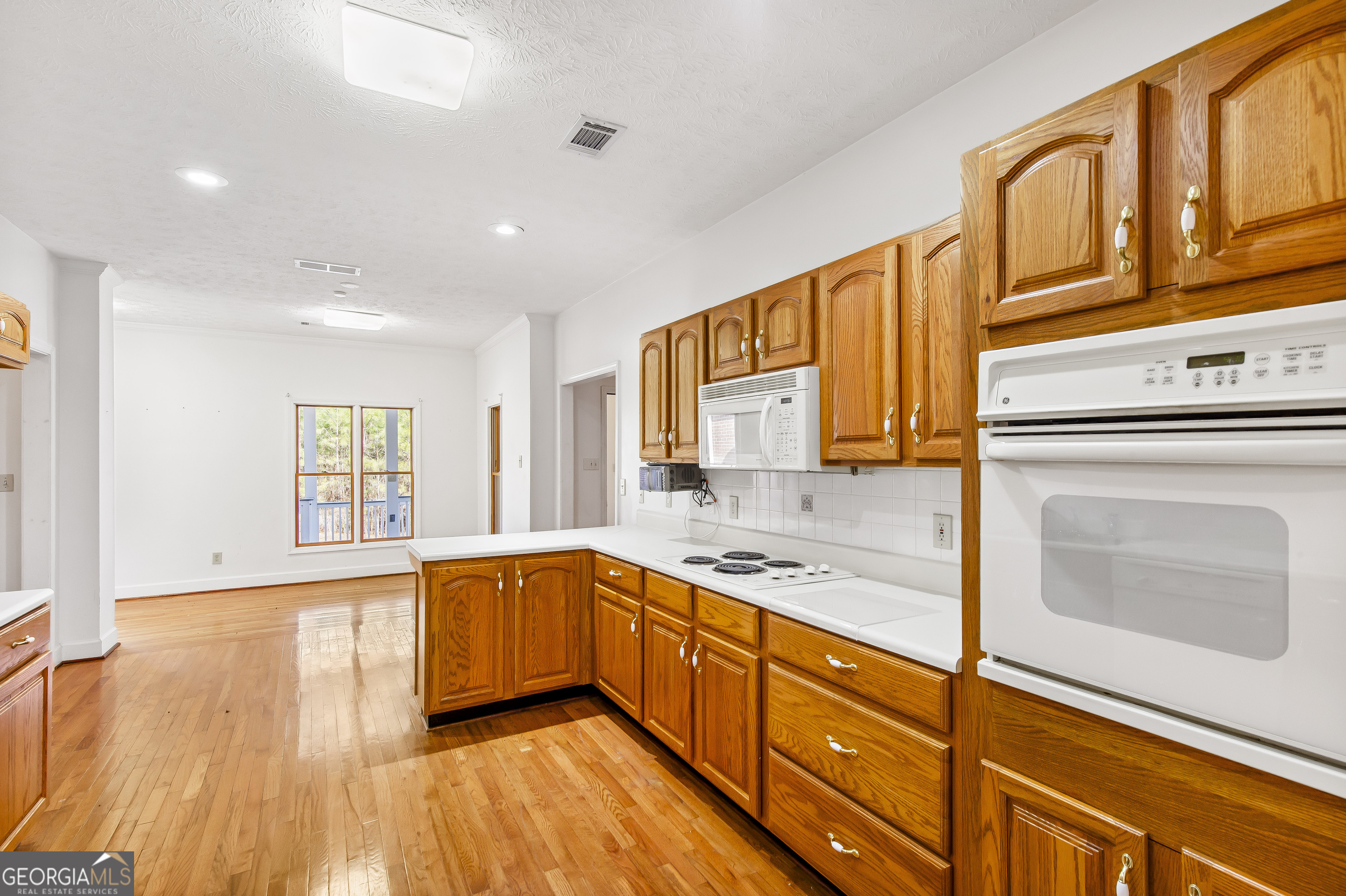 273 High Point Road Buchanan, GA 30113 - Photo 14 of 73 a kitchen with stainless steel appliances granite countertop a sink a stove cabinets and wooden floor