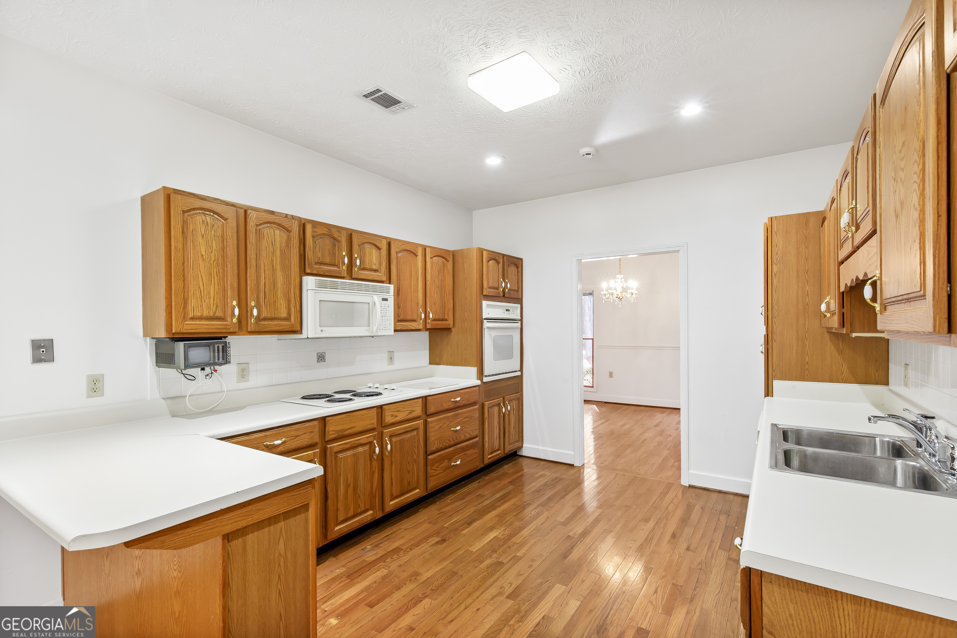 273 High Point Road Buchanan, GA 30113 - Photo 16 of 73 a large kitchen with stainless steel appliances granite countertop a sink and dishwasher a stove with wooden floors