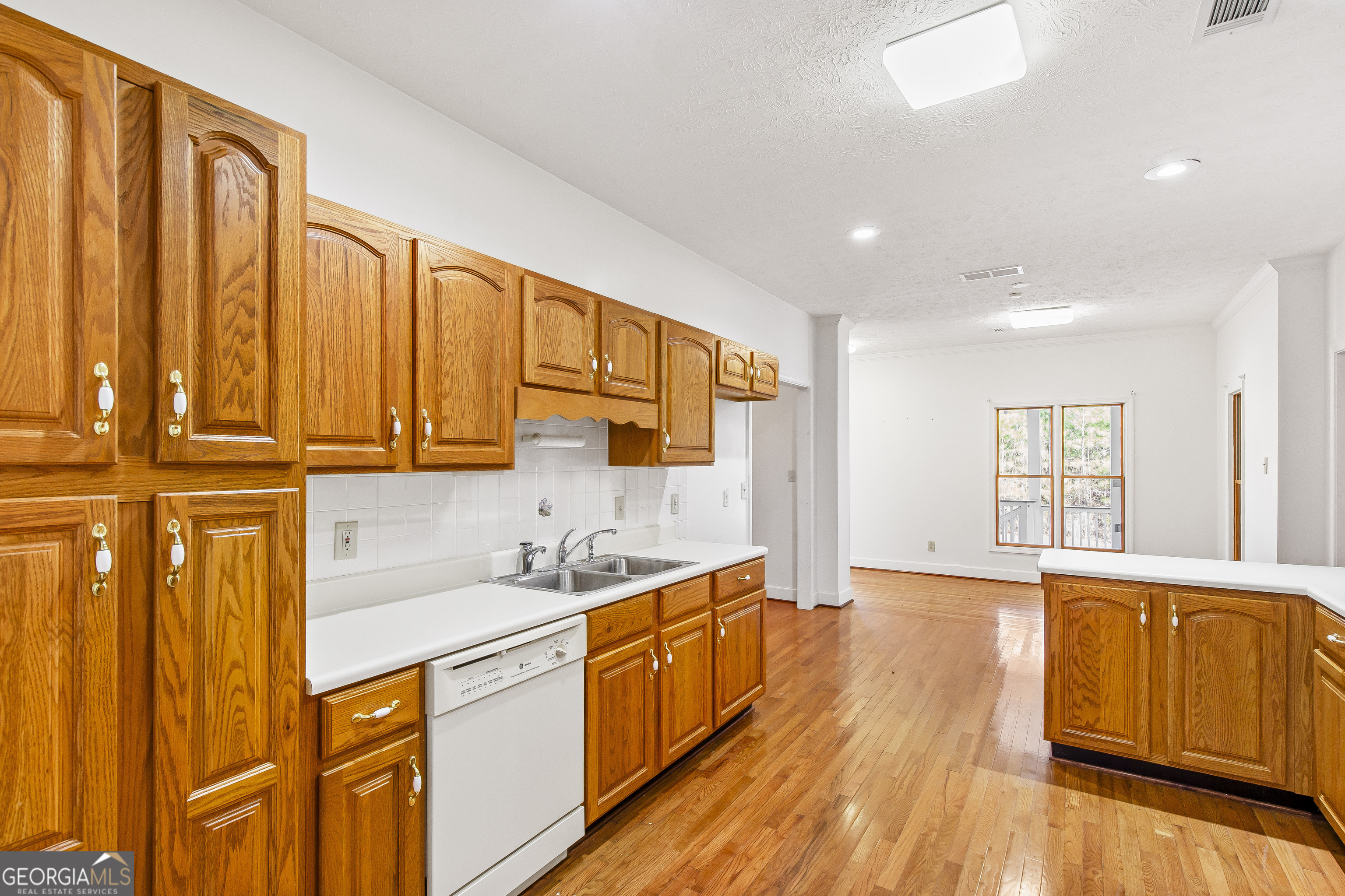 273 High Point Road Buchanan, GA 30113 - Photo 18 of 73 a kitchen with stainless steel appliances granite countertop a sink dishwasher stove and wooden cabinets with wooden floor