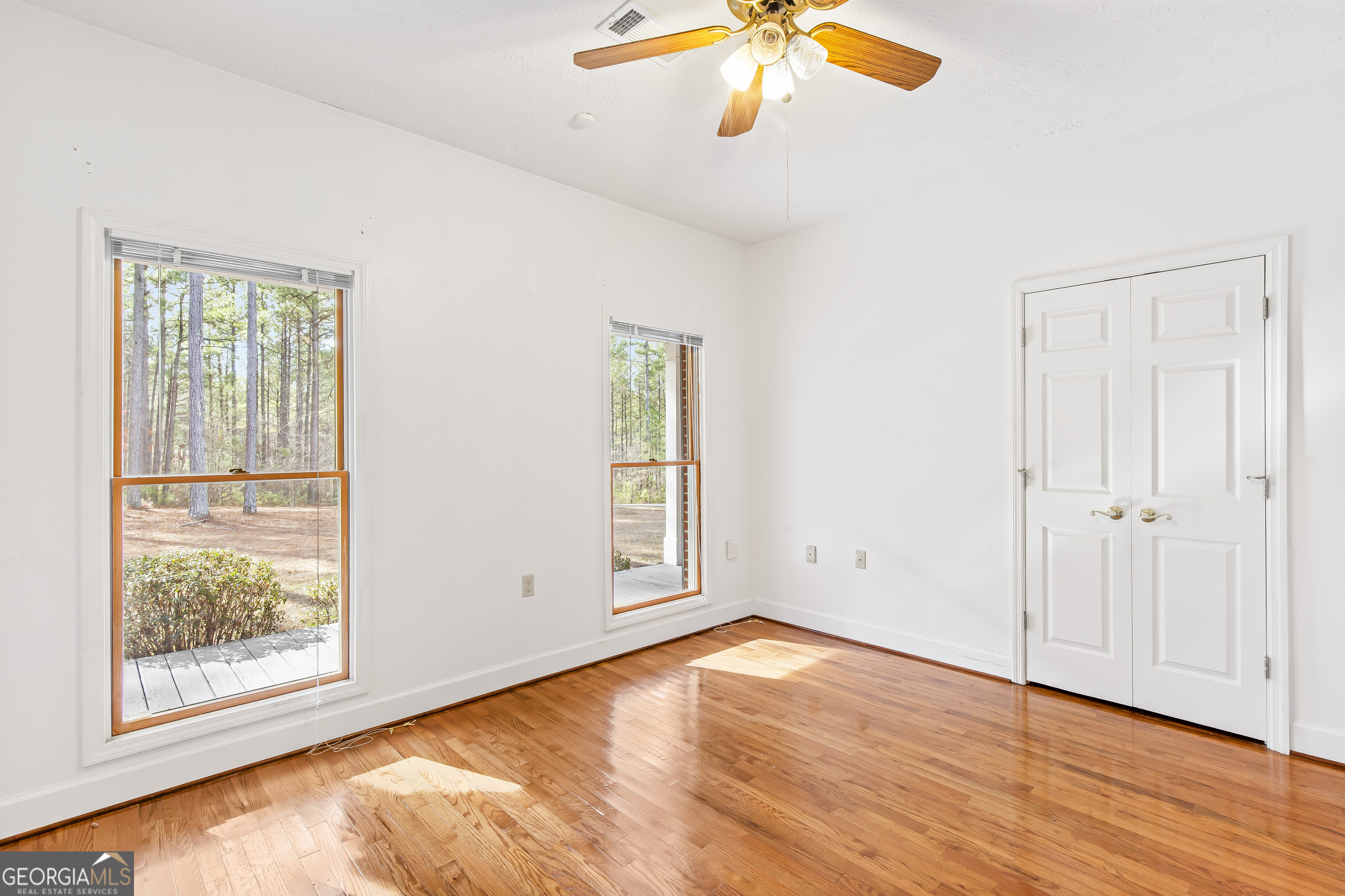 273 High Point Road Buchanan, GA 30113 - Photo 25 of 73 an empty room with wooden floor fan and windows