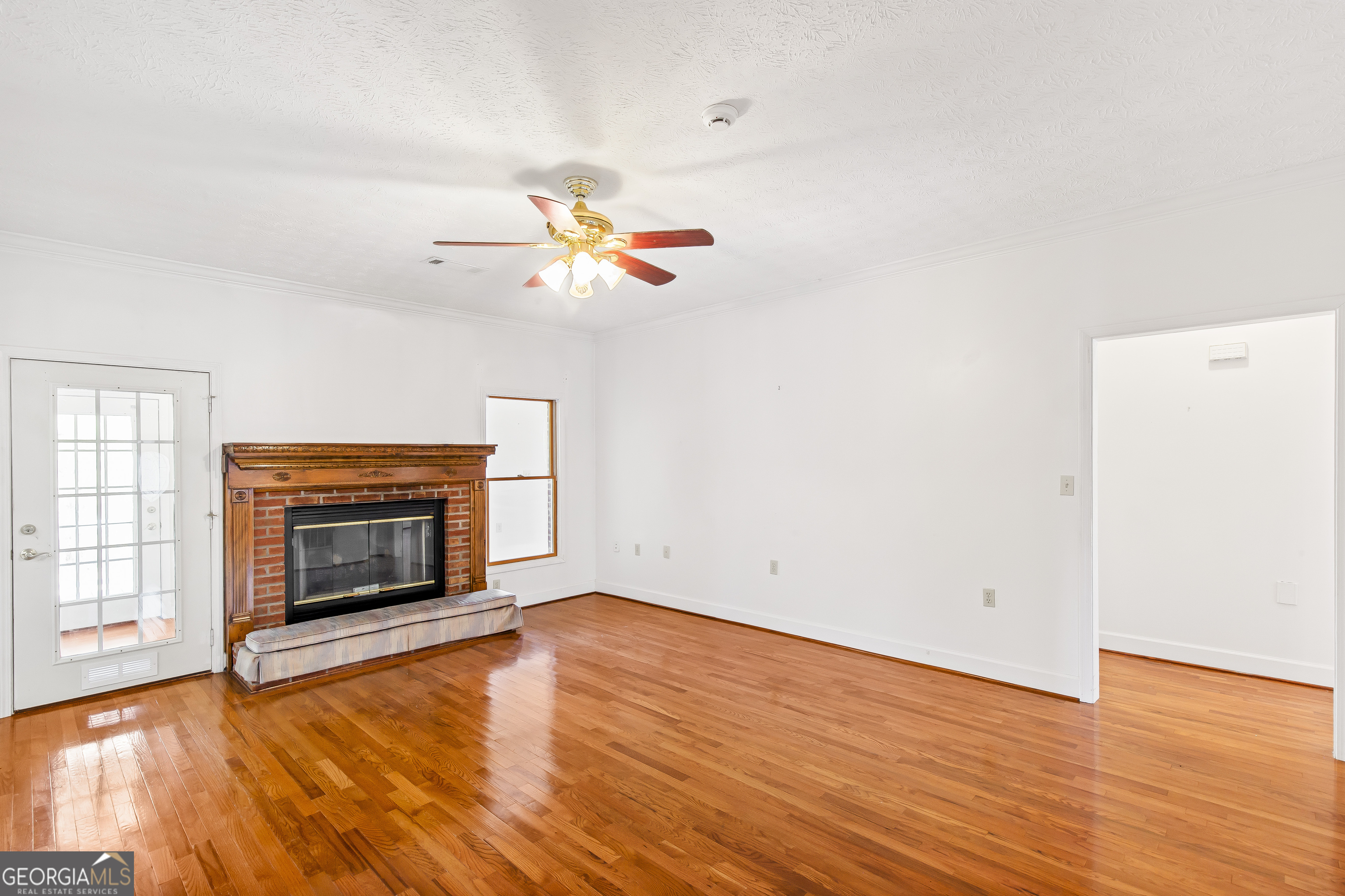 273 High Point Road Buchanan, GA 30113 - Photo 31 of 73 an empty room with wooden floor a fireplace and a window