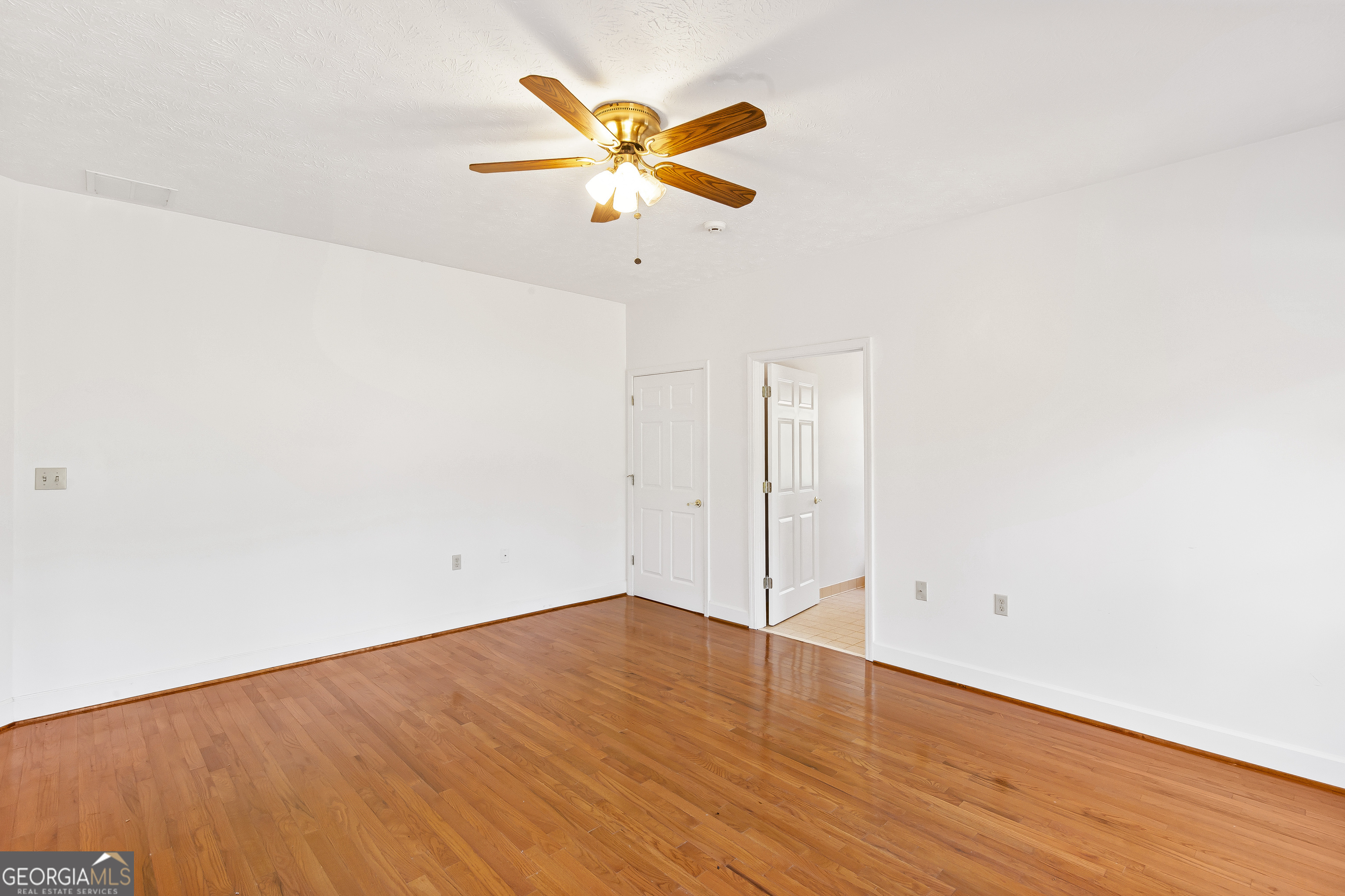 273 High Point Road Buchanan, GA 30113 - Photo 38 of 73 an empty room with wooden floor and ceiling fan