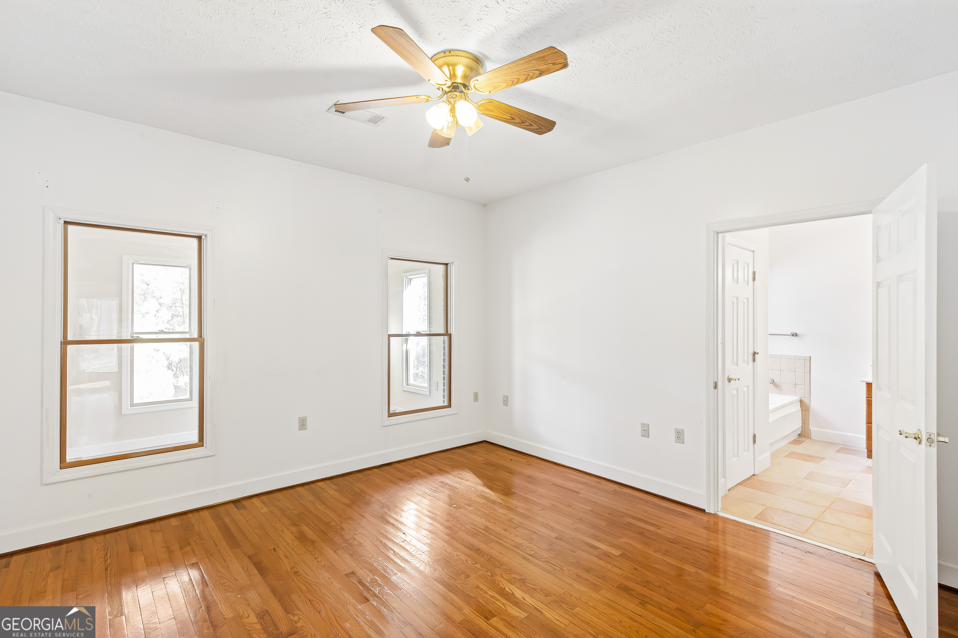 273 High Point Road Buchanan, GA 30113 - Photo 41 of 73 a view of empty room with wooden floor and fan
