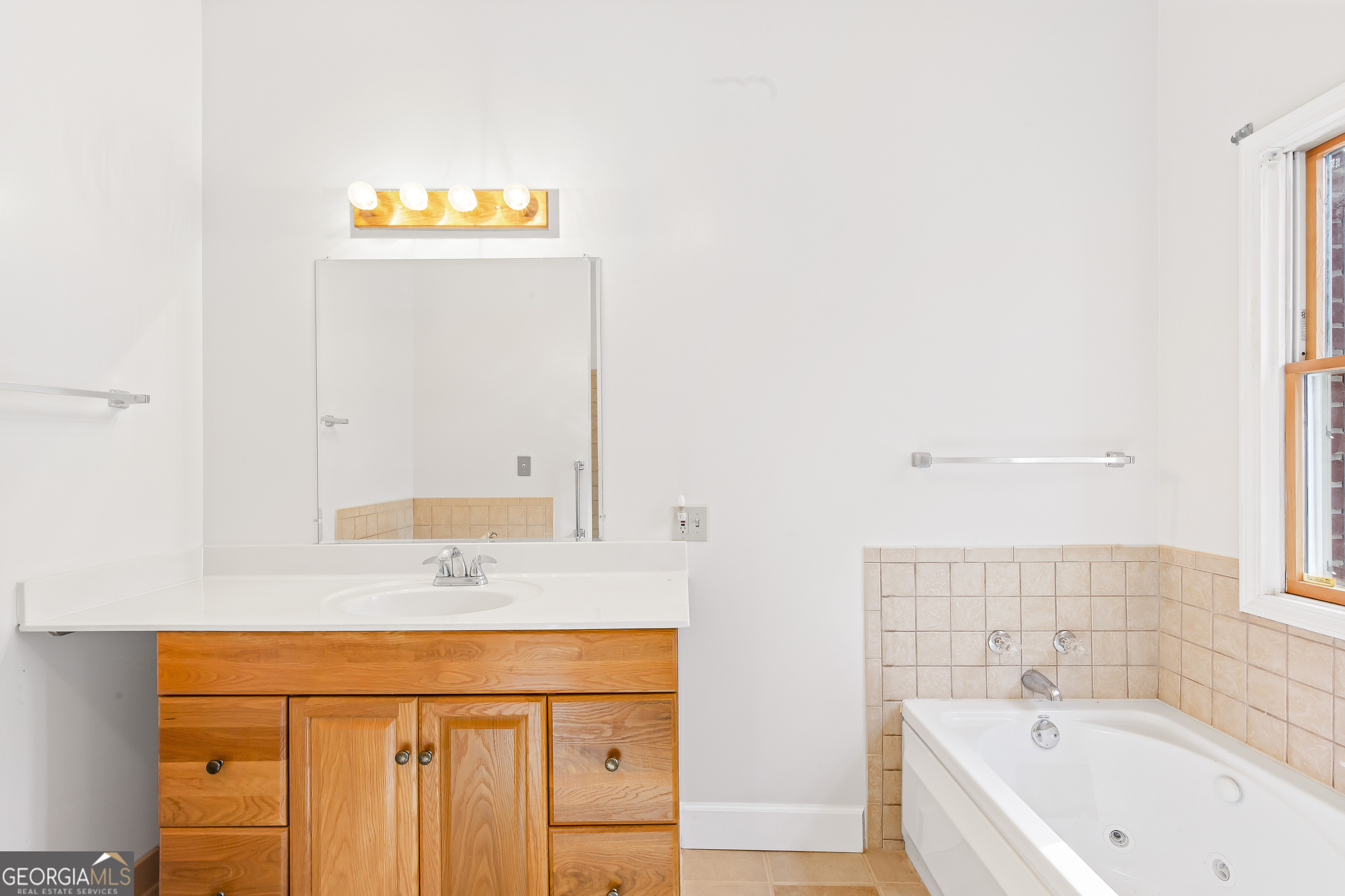 273 High Point Road Buchanan, GA 30113 - Photo 52 of 73 a bathroom with a sink a mirror and a bathtub