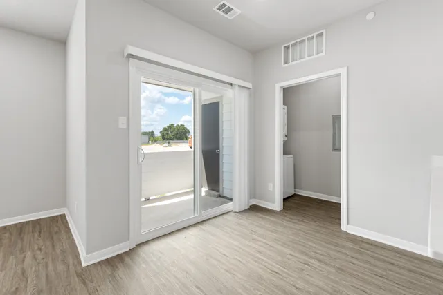 an empty room with a window and ceiling fan