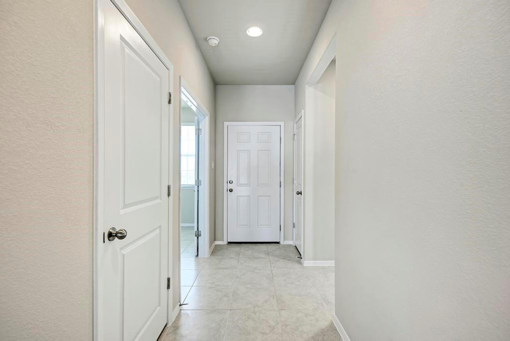 1209 Goforth Road Kyle, TX 78640 - Photo 5 of 32 Clean lines and a neutral palette create an inviting entryway with durable tile flooring.
