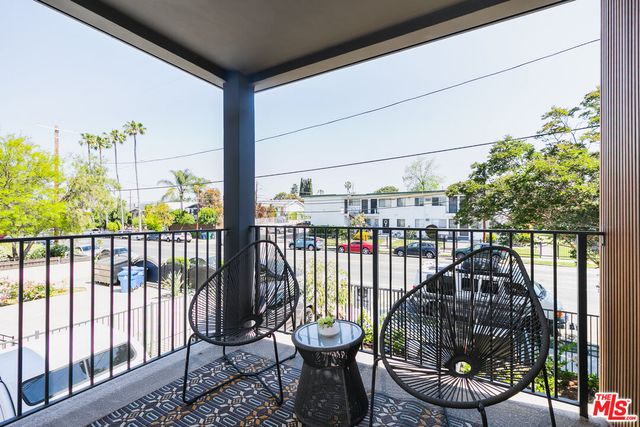 a view of a balcony with chairs
